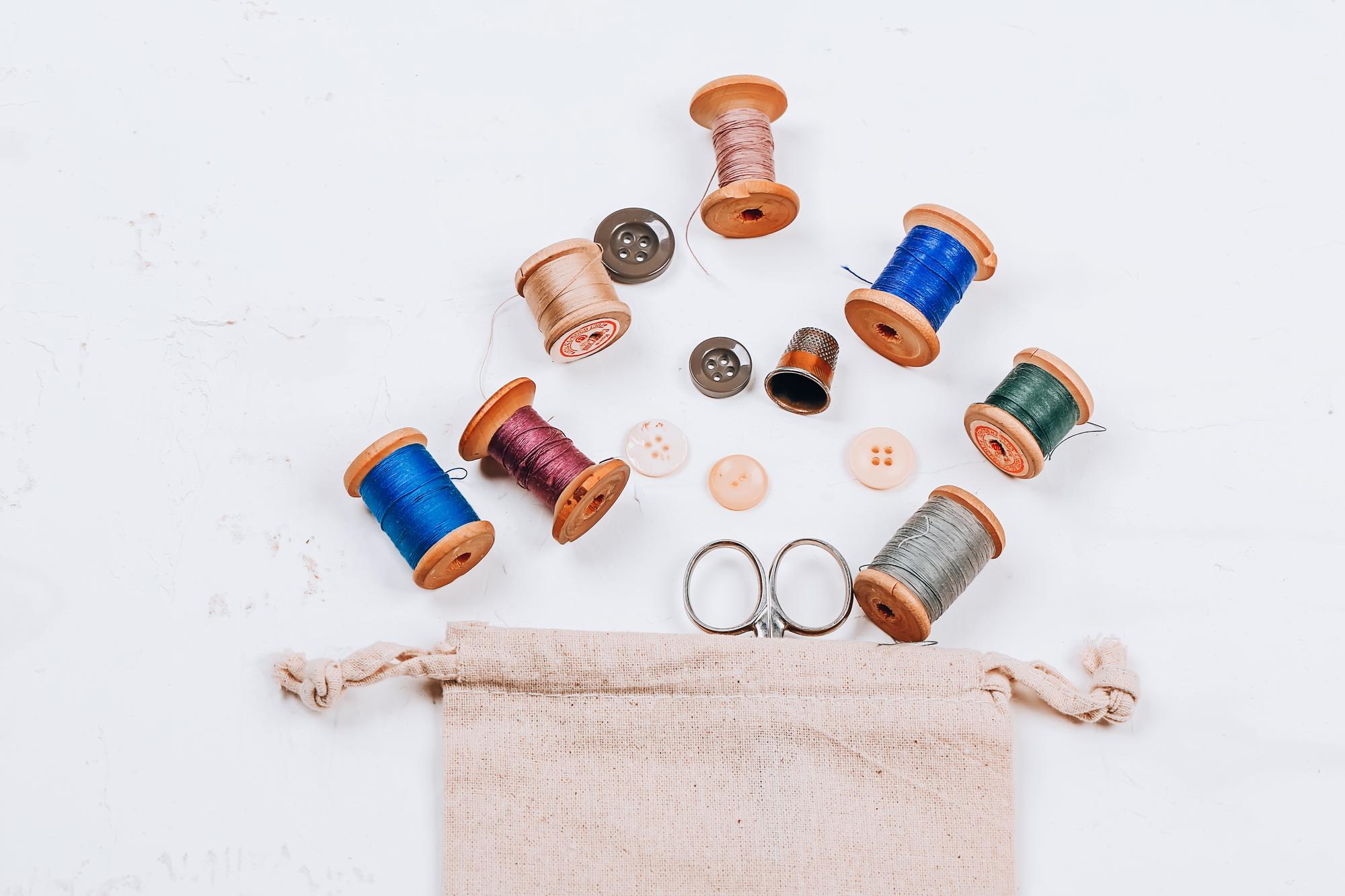 Stitch kit and threads on wooden table
